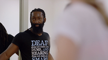 Antoine Hunter/Purple Fire Crow, a Deaf advocate, teaches a dance class.